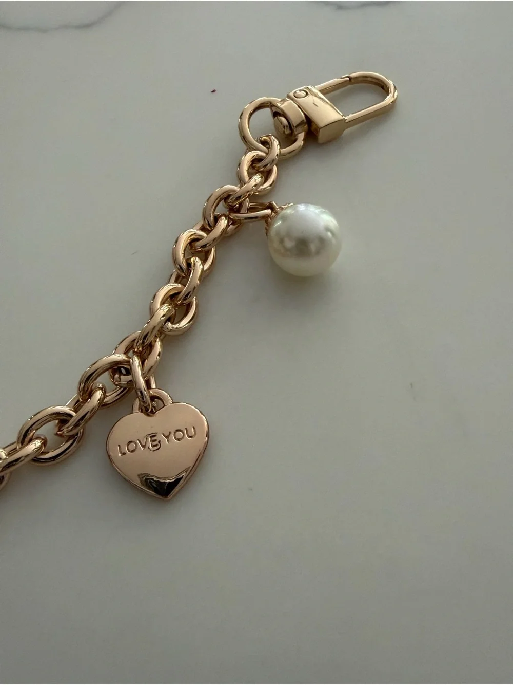 Bag Chain - gold tone with faux pearls and hearts that say “ Iove you”